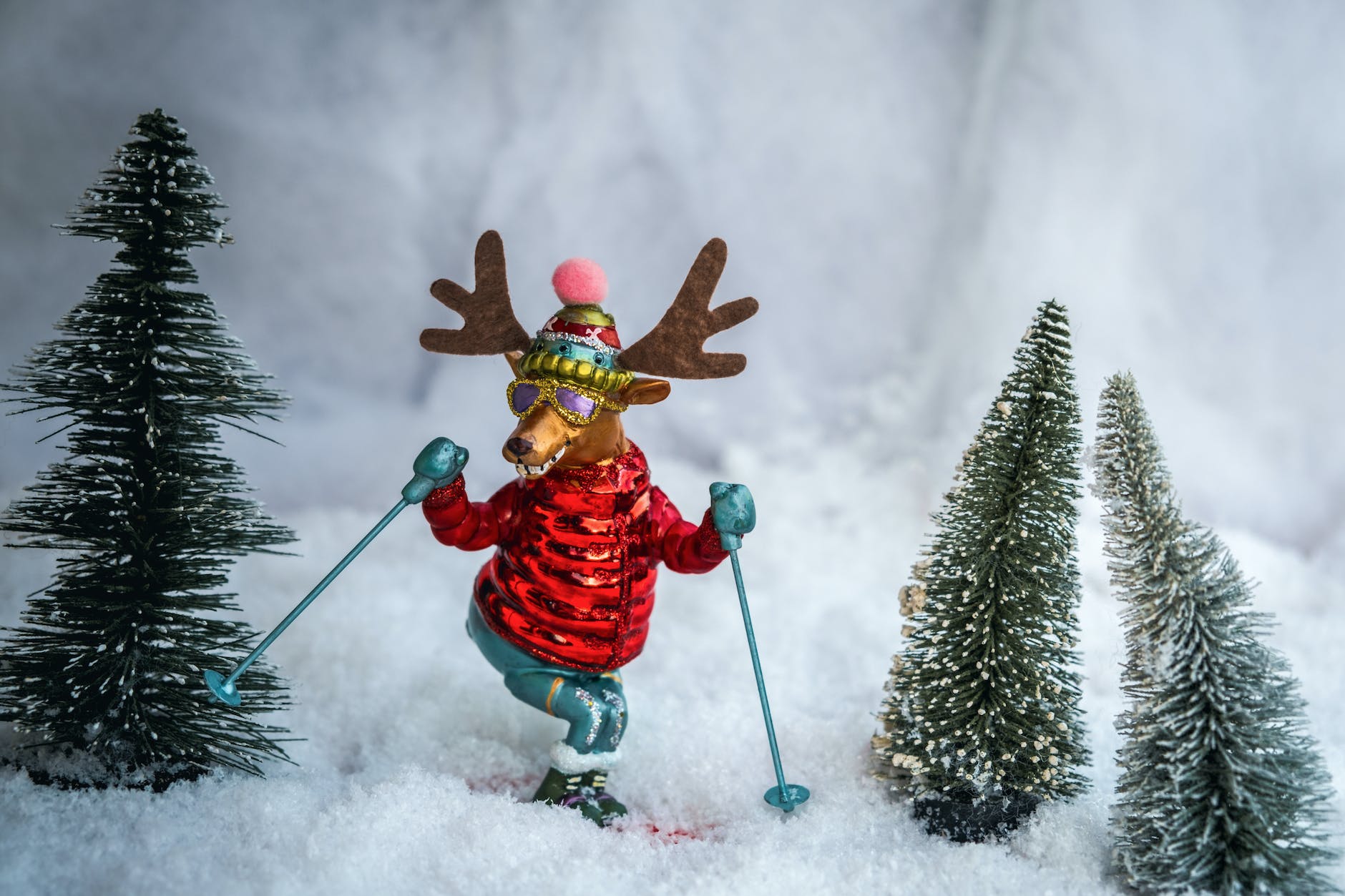 figurines of christmas trees and skiing reindeer