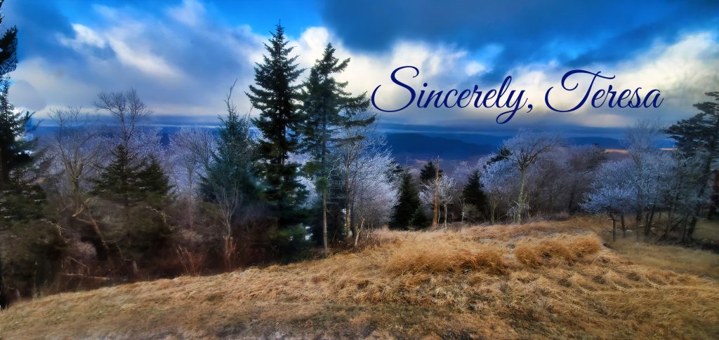 View from mountaintop with mountains in the distance, trees in the forefront, and blue skies, with Sincerely Teresa written on it